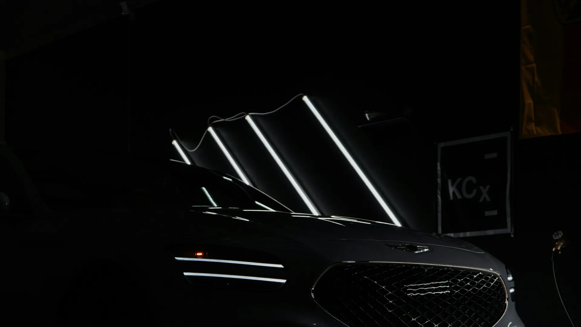 Detailed black car under studio lighting Porter's Car Detailing Leicestershire