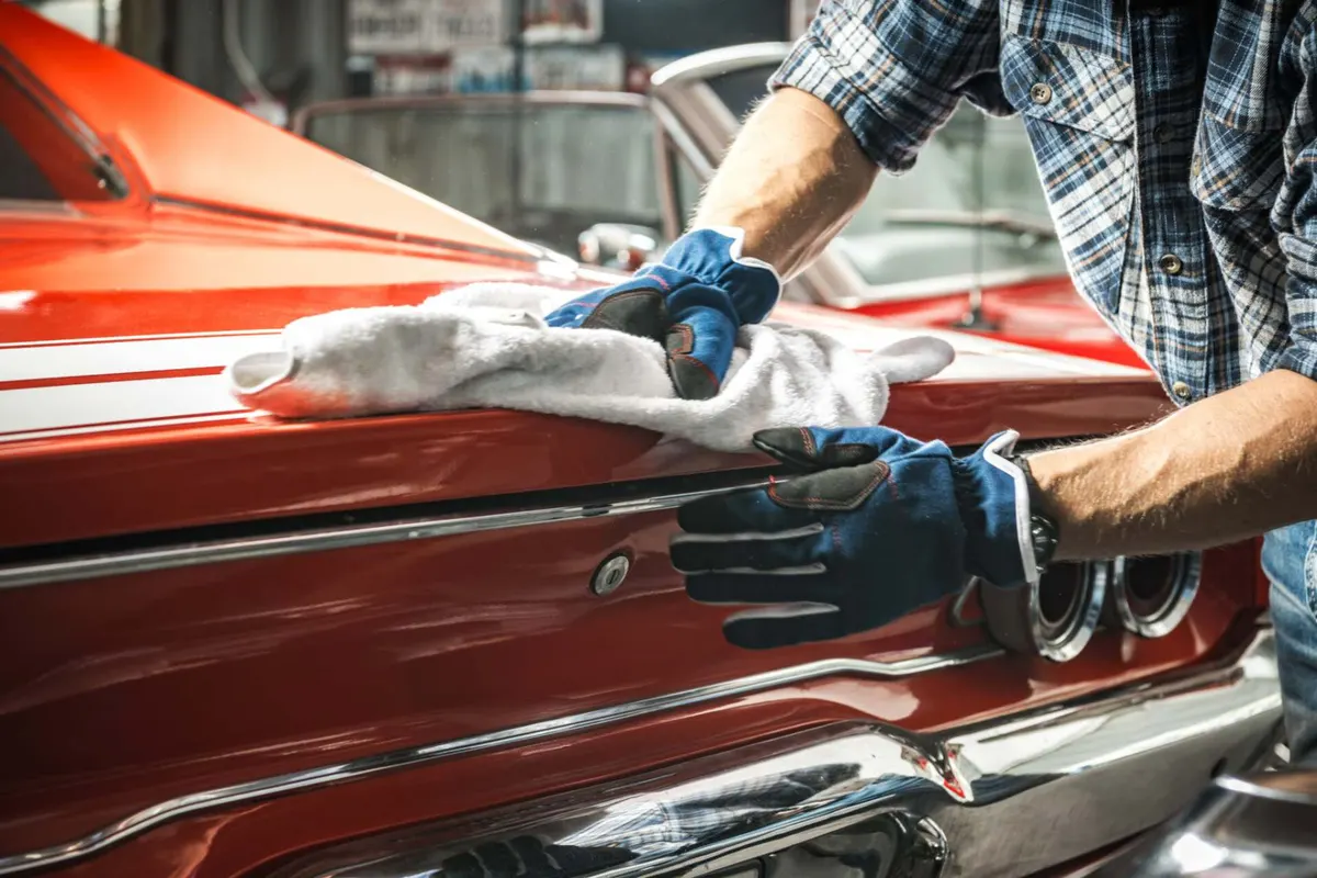 Polishing a classic red car by hand Porter's Car Detailing Leicestershire